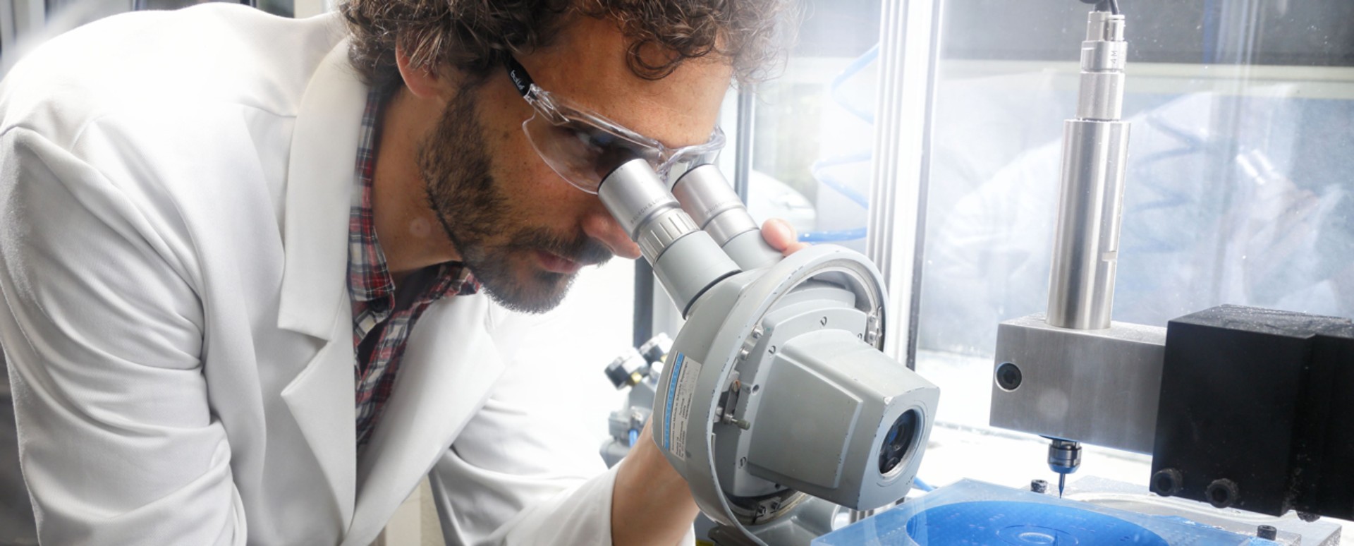 Lab technician performing a visual inspection